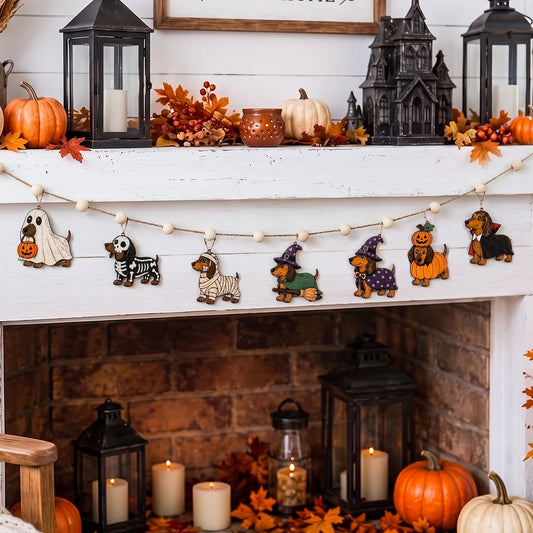 A Halloween-themed wooden dog garland with carved dog figures dressed as ghosts, zebra, poodle, witch, and pumpkin, hanging across a white fireplace mantel decorated with pumpkins, candles, lanterns, and autumn leaves.