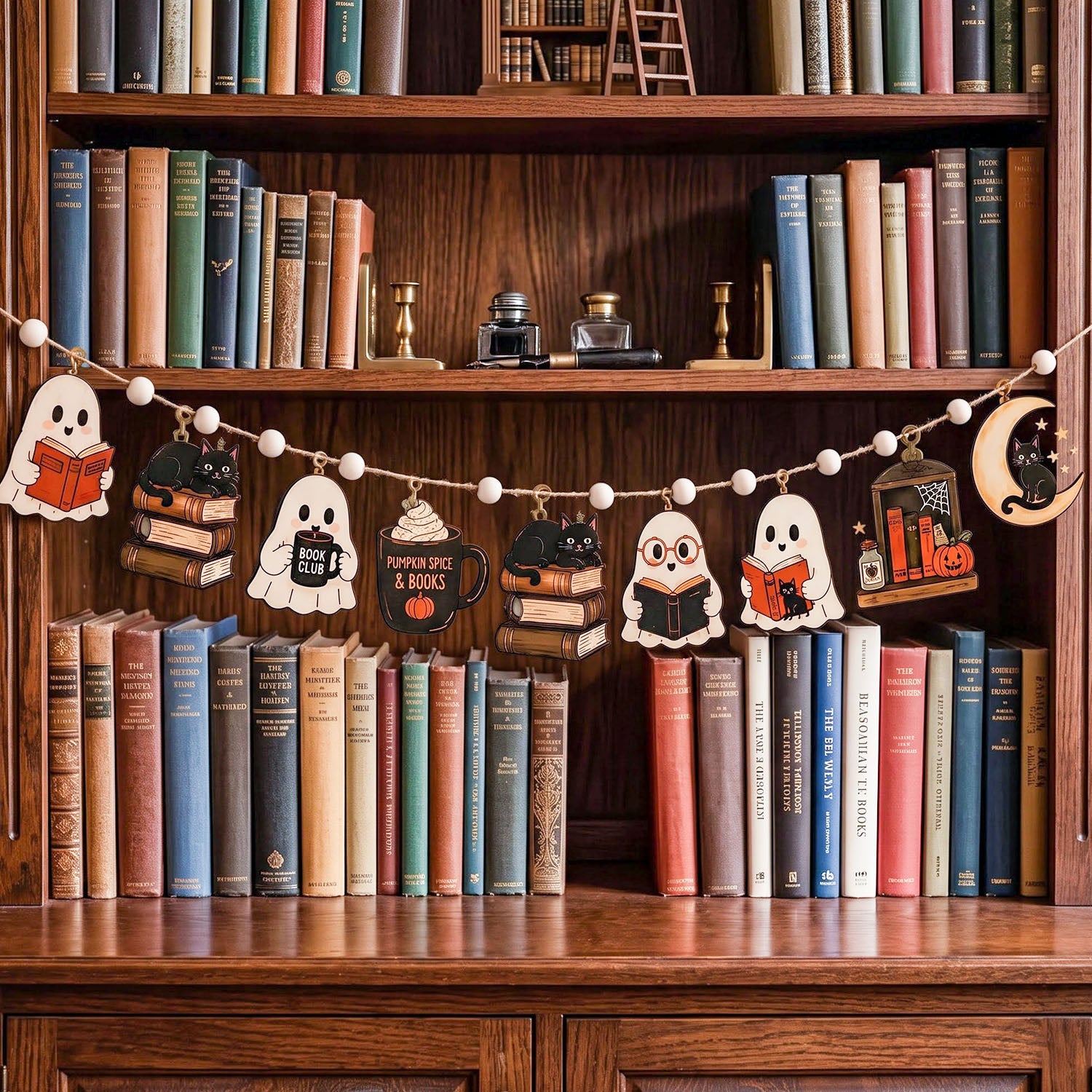 A Halloween-themed wooden bookshelf garland featuring cute cartoon characters reading books, ghosts, a mug, and a moon, hung across a wooden bookshelf filled with vintage books.