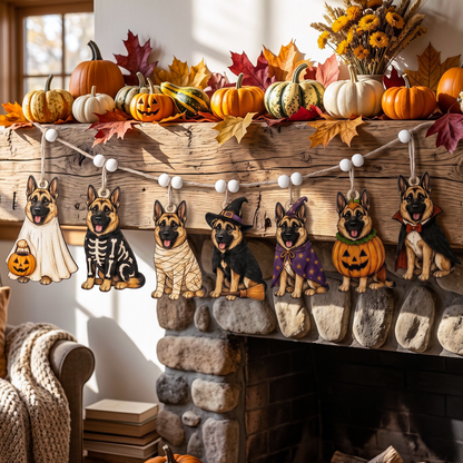 Halloween fireplace mantel decorated with pumpkins, fall leaves, sunflowers, and a string of dog-shaped ornaments in different costumes including ghost, skeleton, bandage, witch, pumpkin, and superhero outfits.