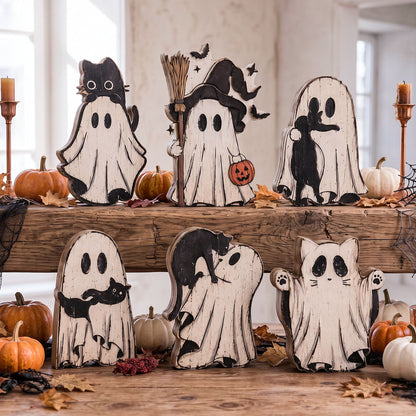 A set of Halloween-themed wooden ghost cutout decorations displayed on rustic wooden shelves, surrounded by small pumpkins, spiderwebs, and candles.